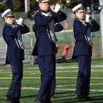 Trombones move in unison on the field.