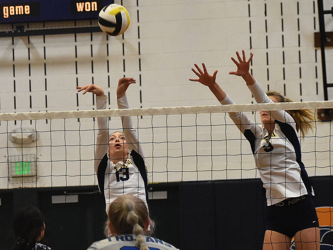 Spartans Isabel White and Holley McFadden block Olympics kill attempt.