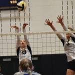 Spartans Isabel White and Holley McFadden block Olympics kill attempt.