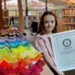 Brynn Blanchard courtesy photo
Ezra Strawn, 12, poses with a certificate from Guinness World Records verifying her world record displaying 1,650 origami dogs May 16 at the Bainbridge Island Public Library.
