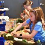Hanna-Lisa Barlak works on a car to enter in the Great Zucchini Race.