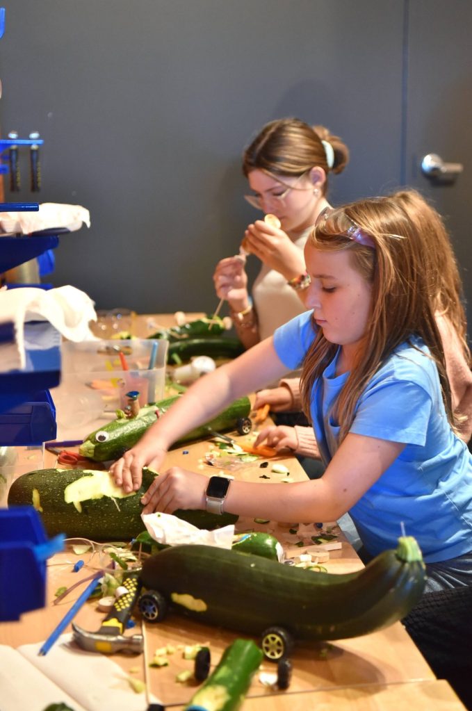Hanna-Lisa Barlak works on a car to enter in the Great Zucchini Race.