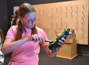 Nancy Treder/Kitsap News Group Photos
Bainbridge sophomore Cadence Hill carves out the center of a zucchini to enter in the Great Zucchini Race.
