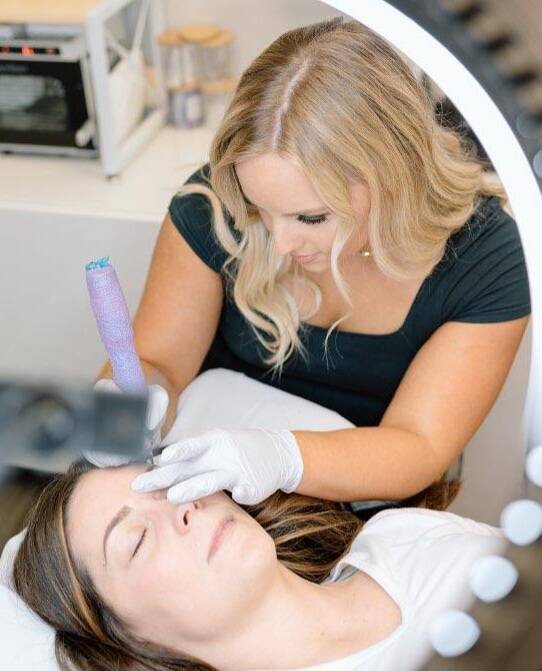 Brianna Madison courtesy photo
A mirror reflection shows Brianna Madison (top) working with a customer.