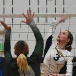 Jameson Payne smashes the ball past a Port Angeles defender.