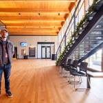 Matt Longmire, communications and development coordinator, waits for the crowd to arrive in the huge and beautiful lobby area.