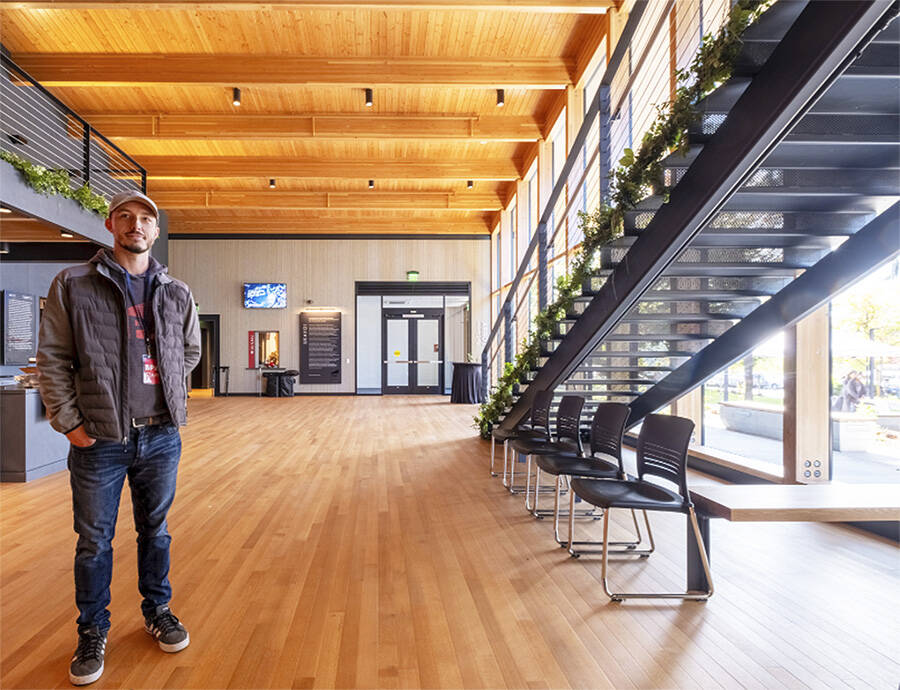 Matt Longmire, communications and development coordinator, waits for the crowd to arrive in the huge and beautiful lobby area.