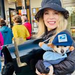 Denise Stoughton, founder of Uniquely Bainbridge, dressed up like a mailbox and her dog Tula as a postman at Halloween.
