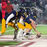 The Spartan offensive line stands at the ready near midfield at a frigid Kitsap Bank Stadium.