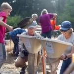 Cameron Karsten courtesy photos
Land Trust volunteers fill biodegradable bags with soil to be used in the reconstruction of the streambank.