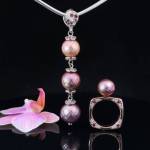 The 3 pearl pendant features 3 natural Edison freshwater pearls. A shimmery copper, rose purple and purple. Accented with Rhodolite Garnets and Diamonds.