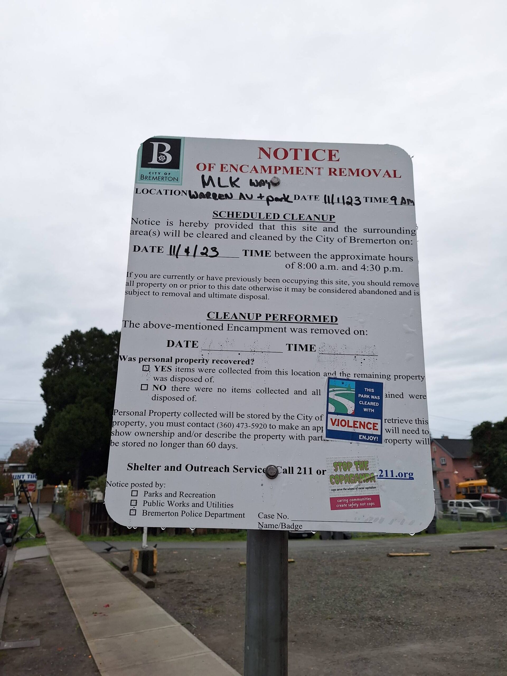 Backlash against the citys efforts have been communicated from homeless advocates through stickers on signs like this, reading, This park was cleared with violence. Enjoy! and Stop the copaganda.