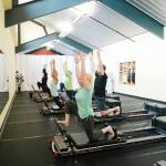 Arlene Harris leads a session at The Pilates Studio at New Motion on a device known as the Reformer.