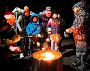 Nancy Treder/Kitsap News Group Photos
Roasting marshmallows was just one of many activities going on Nov. 25 in Winslow to celebrate the holiday season. The annual tree-lighting event included performances by local bands and choirs.