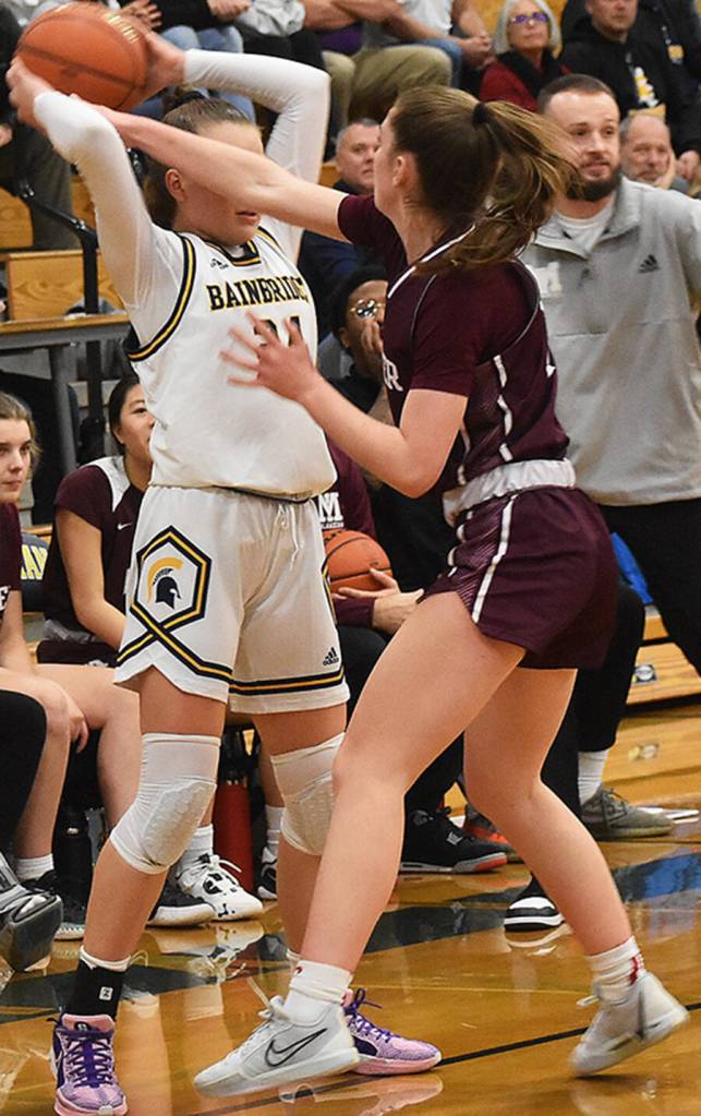 Islander Caitlin Monahan pokes the ball from Spartan Bella Ramirez.