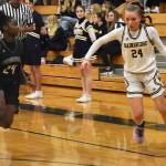 Nicholas Zeller-Singh/Kitsap News Group Photos
Bella Ramirez drives past Peninsulas Grace Richardson.