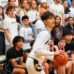 Nicholas Zeller-Singh/Kitsap News Group Photos
Spartan Kaden Thielman scores a three-point shot from the corner.