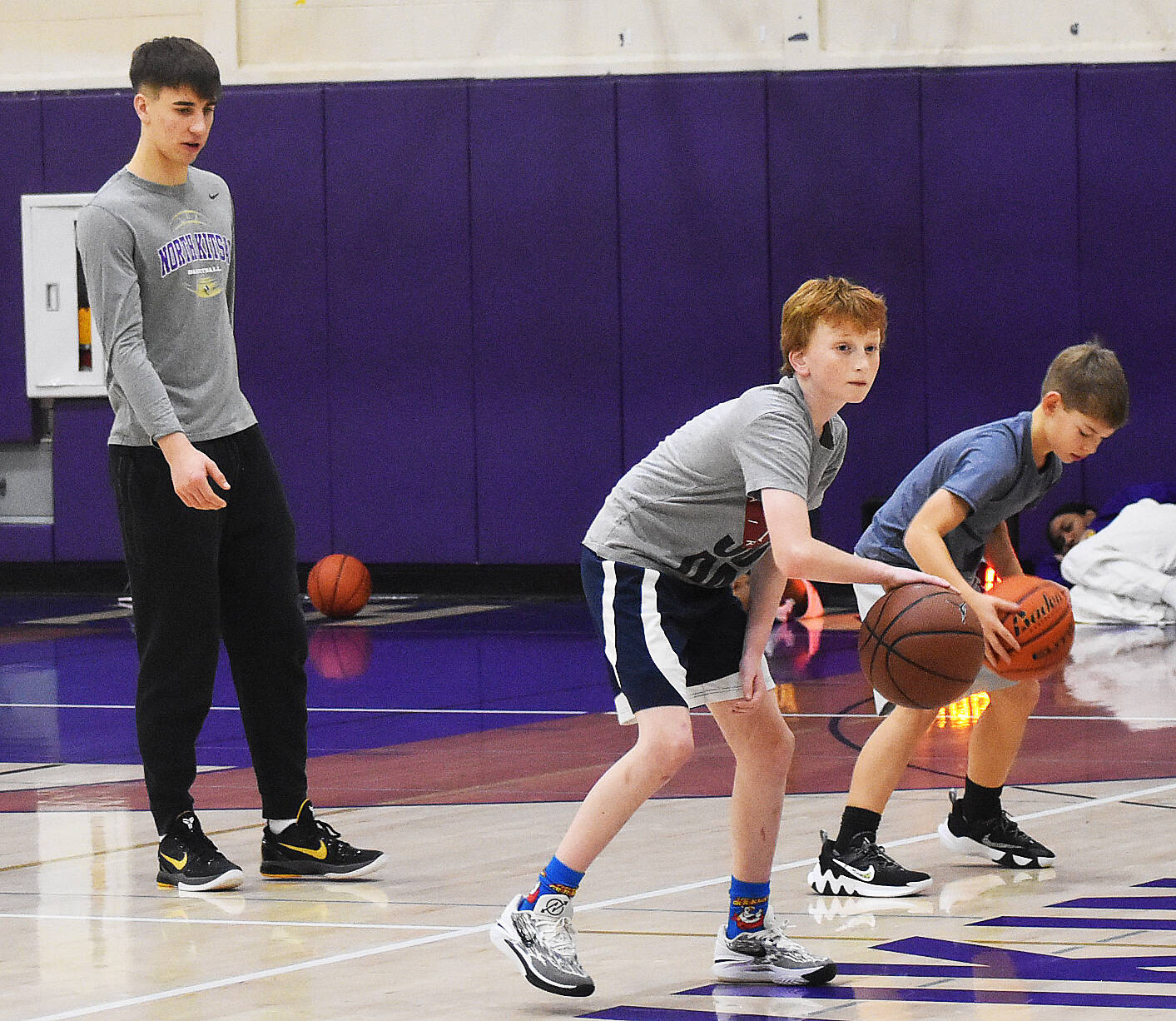 Viking Cade Orness helps run a basketball camp during winter break.