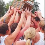 BHS girls celebrate state championship in lacrosse with their coach.