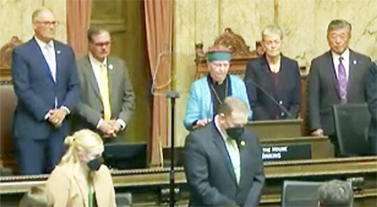Steve Powell/Kitsap News Group
Rev. Dee Eisenhower of Bainbridge Island gives the opening prayer at Gov. Jay Inslees State of the State address.