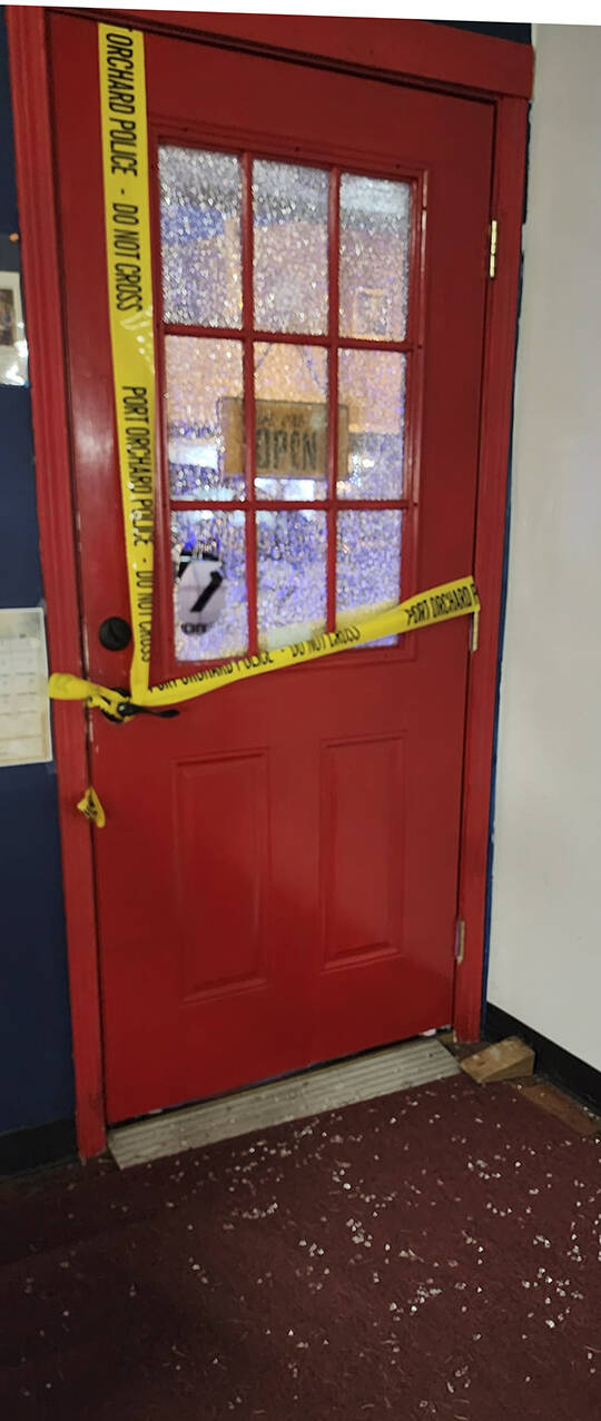 Shattered glass from the front door covers the store floor.