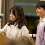 Gina Hasagawa and Simone Newman, Woodward Middle School students, debut their new publication, the Woodward Gazette, at the meeting.