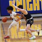 Nicholas Zeller-Singh/Kitsap News Group
Knight Aaron Matthews dribbles past Spartan Teddy Hanlon.