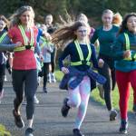 Ann Browning, left, coach and co-director of Go Run Bainbridge, jogs with Emersen Ewing, Frankie ONell and her team of girls at a practice.