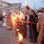 Sons of Norway Vikings light their torches and get set to march through downtown Poulsbo on their way to the waterfront to light the bonfire.