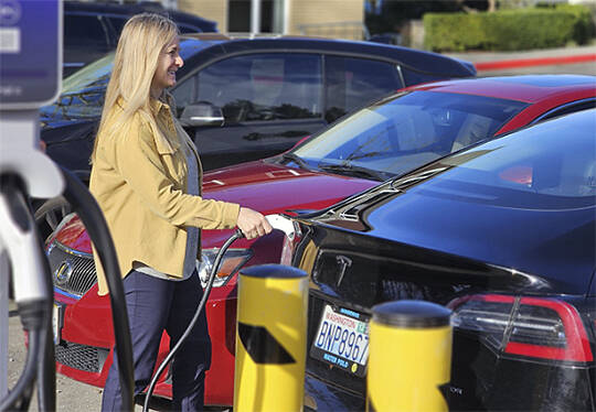 PSE courtesy photo
Using an electric vehicle charger.