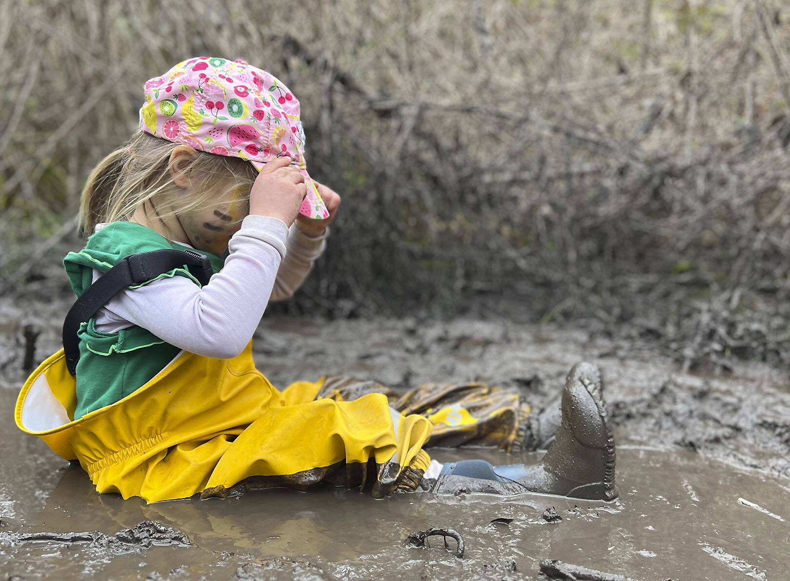 A child plays in the mud kitchen at Magnolia Forest Preschool.