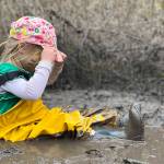 A child plays in the mud kitchen at Magnolia Forest Preschool.