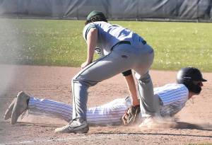 Nicholas Zeller-Singh/Kitsap News Group photos
Bainbridges Braden French dives safely back into first base after a pickoff attempt.