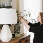 Maggie Stephens arranges some greenery in a vase for a client.