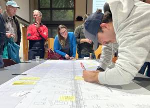 Molly Hetherwick/Kitsap News Group photos
James Allen adds a note to a topographical map of Valley Road.