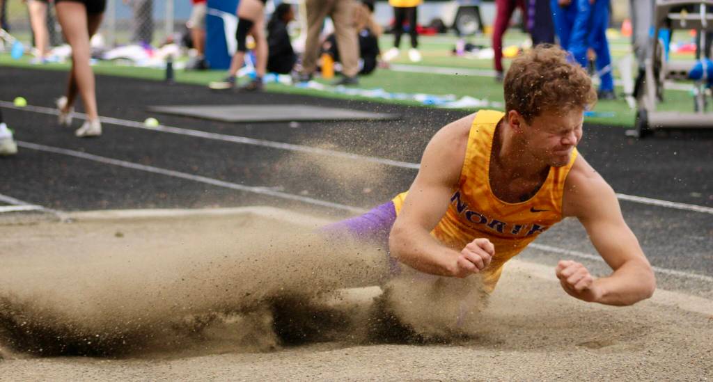 North Kitsaps Logan Sloman lands in the sand during long jump.