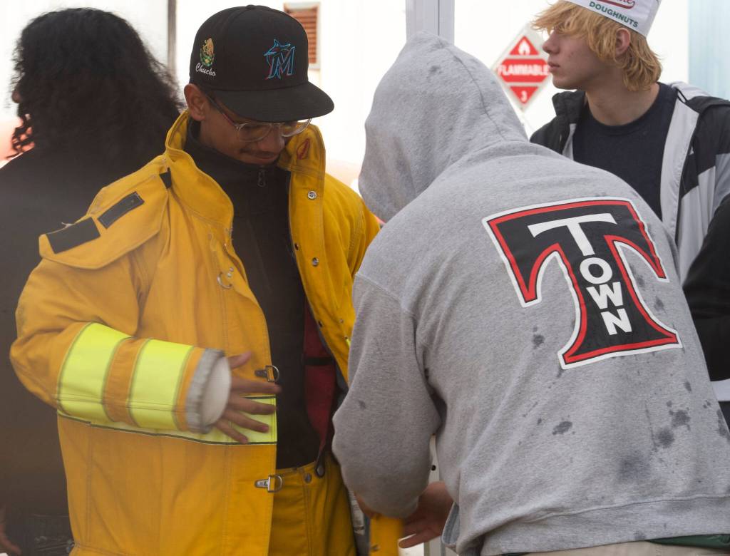 A teacher assists a student from Kent-Meridian High School.