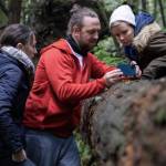 Washington Filmworks courtesy photo
Ingress director Rachel Noll James, left, cinematographer Dan Clarke and co-producer Sienna Beckman lean on a log behind the scenes of the film.