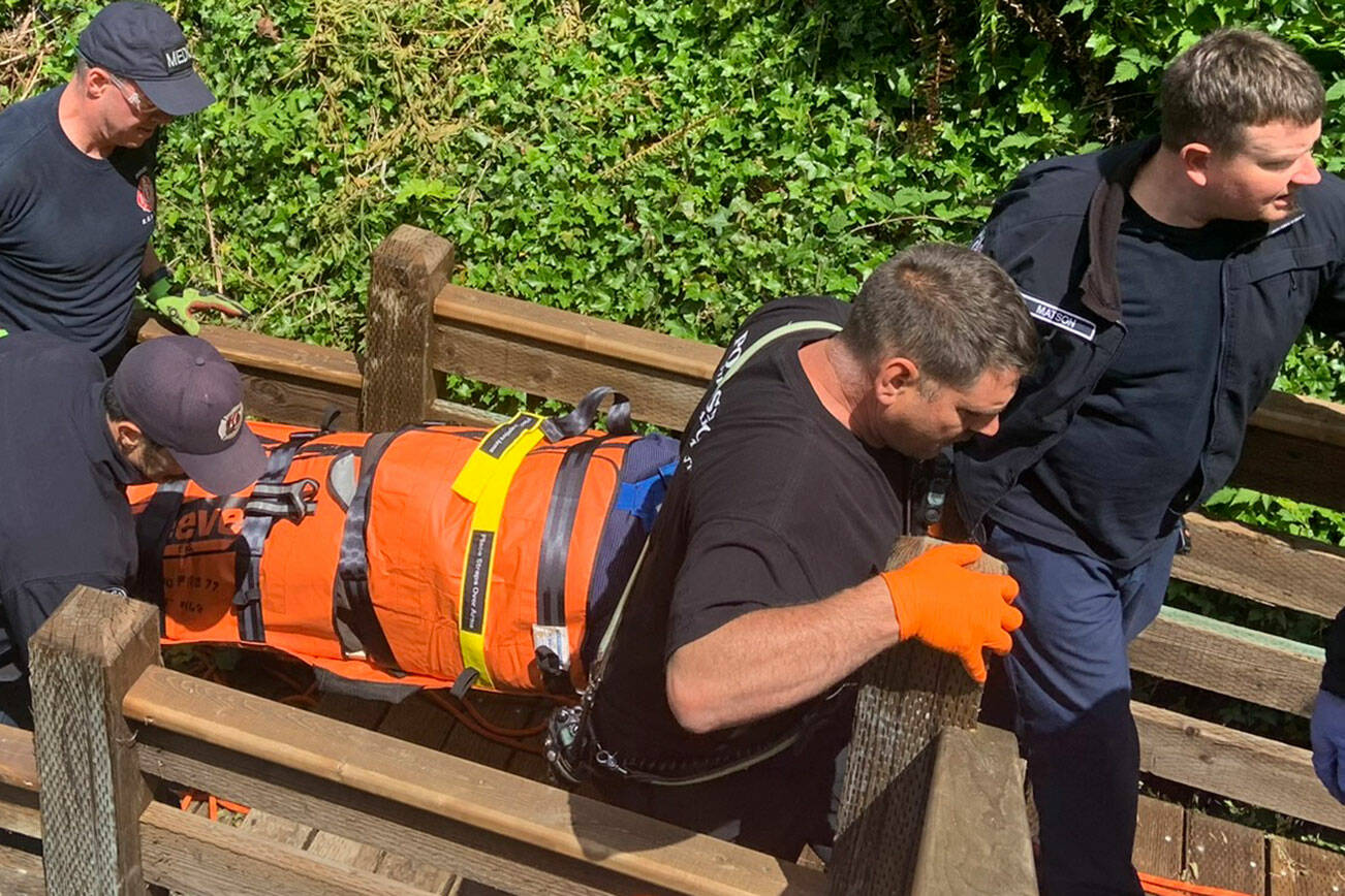 PDF courtesy photo
First responders bring the woman up a flight of stairs after she fell over 20 feet and suffered a head injury.