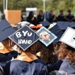 Some graduates proudly show wear they plan to go to school next by decorating their caps.