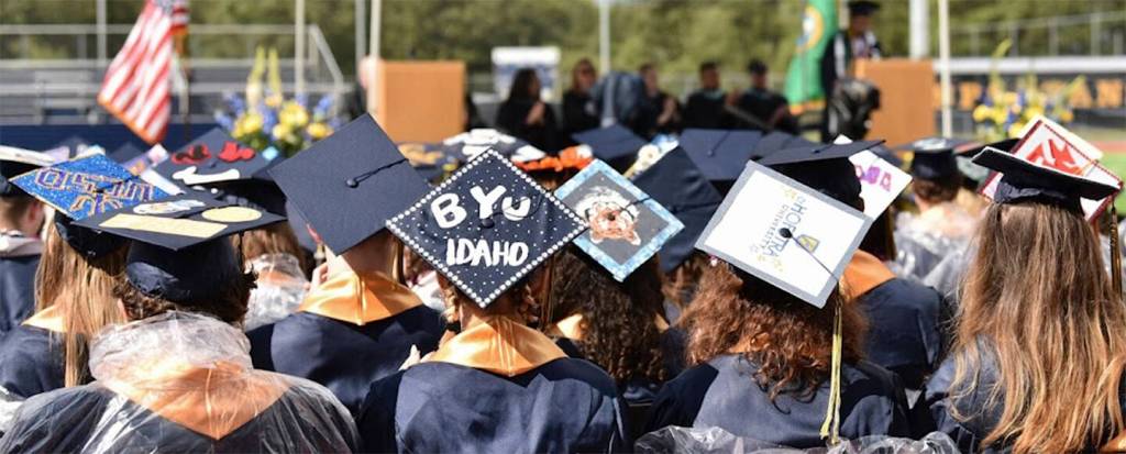 Some graduates proudly show wear they plan to go to school next by decorating their caps.