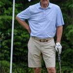 Brian Billick waits for his team members to putt.