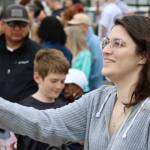 Danielle Edwards waves her flag while watching the USS Ronald Reagan arrive in Bremerton.