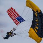 Damon Williams/Kitsap News Group photos
A U.S. flag flown in via parachute kicks off the airshow at the Bremerton Airport Aug. 17.