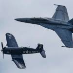 Flying in the heritage pattern are a Navy F4U Corsair, left, and a VFA-122 Flying Eagle.