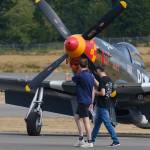 Two youths walk around the airport in Bremerton looking at some of the planes before takeoff.