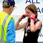Vivian Gray receives her gold medal for co-winning the girls overall competition.