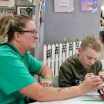 Elisha Meyer/Kitsap News Group photos
Seisha Hassett sits with her son Timothy, who is hard at work sewing fabric together at the Kitsap Fair and Stampede.