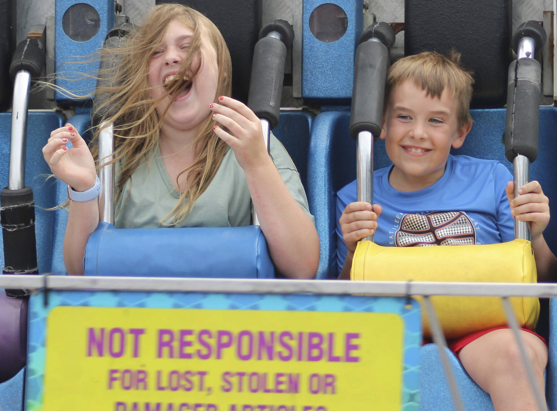 Sofie and Gabe cant help but scream and hang on during a carnival ride at the Kitsap Fair and Stampede, which runs through Sunday.