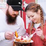 Rain or shine funnel cake always tastes good as Ty Brewen and Megan Drinnon can attest.